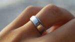 Person wearing a smart ring on their finger, showcasing advanced technology for health tracking, fitness monitoring, and wellness in everyday life.